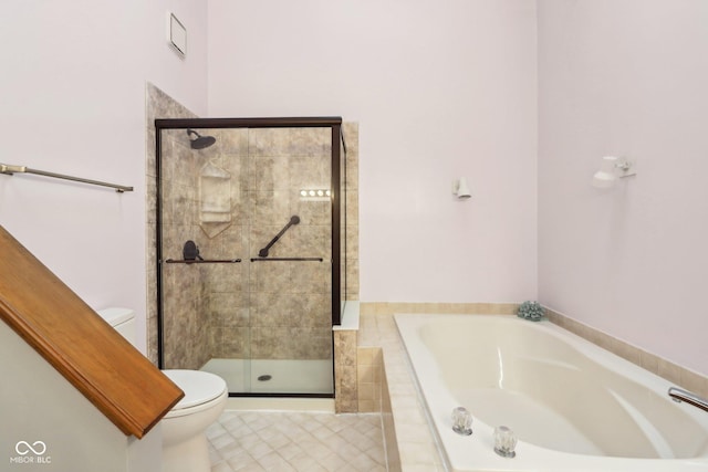 bathroom featuring shower with separate bathtub and toilet