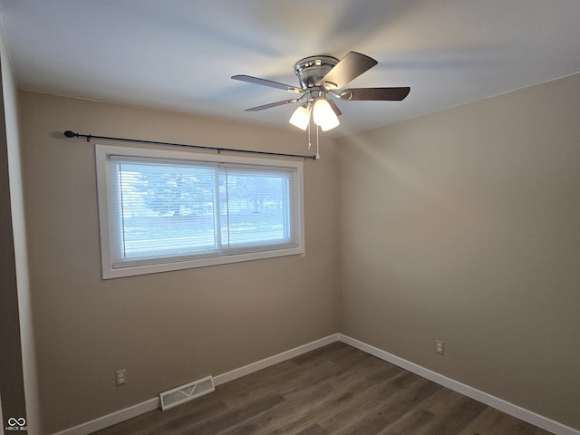 unfurnished room featuring ceiling fan and dark wood-type flooring