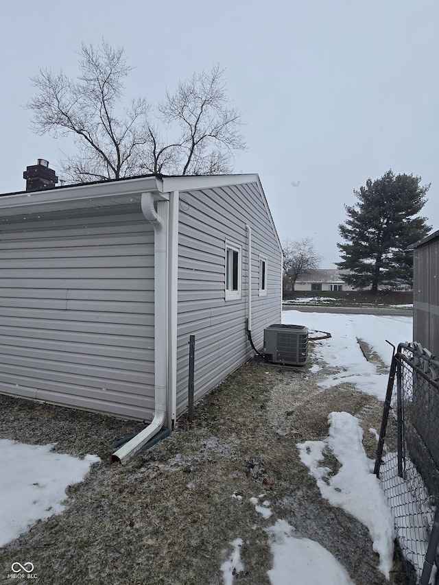 snow covered property featuring central air condition unit