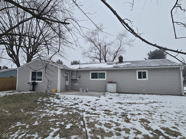 view of snow covered back of property