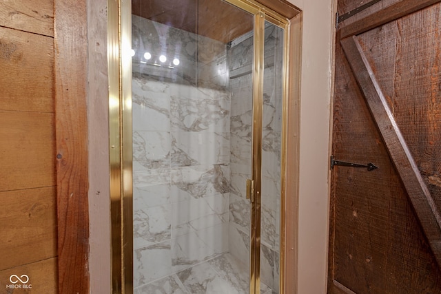 bathroom with a shower with shower door