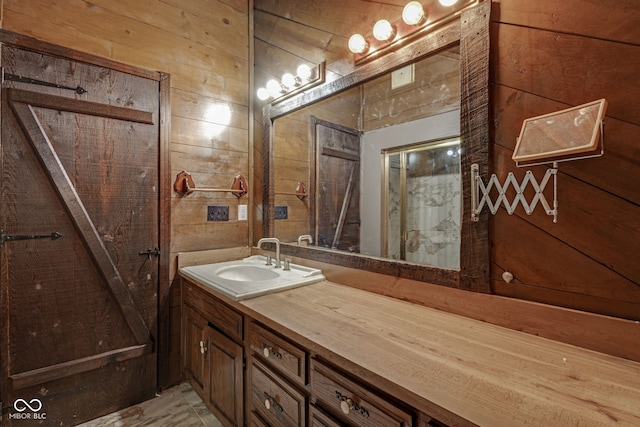 bathroom with vanity and wooden walls