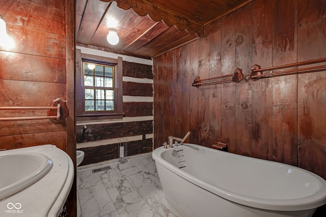 bathroom with wood ceiling, wooden walls, and toilet