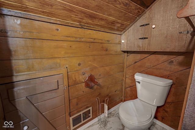 bathroom featuring wood ceiling, lofted ceiling, toilet, and wood walls