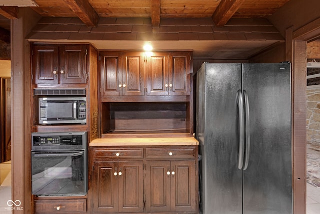 kitchen with fridge, black oven, beam ceiling, and wood ceiling