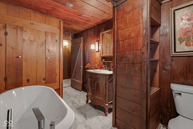 bathroom featuring vanity, a tub to relax in, wooden ceiling, toilet, and wood walls