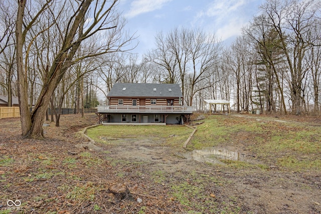 rear view of property featuring a wooden deck