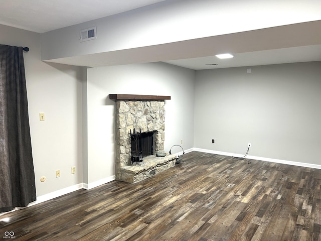 unfurnished living room featuring dark hardwood / wood-style flooring and a fireplace