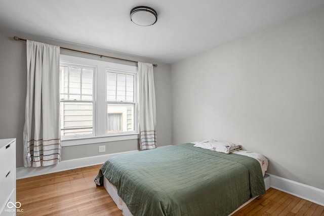 bedroom featuring baseboards and wood finished floors