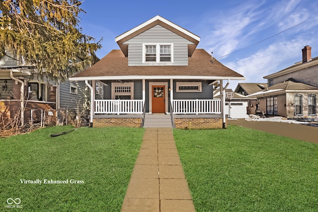 bungalow-style house featuring a porch, roof with shingles, and a front lawn