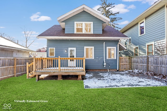 back of house with a fenced backyard and a yard