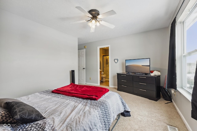 carpeted bedroom featuring ceiling fan and ensuite bathroom