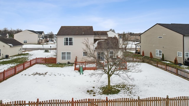 snow covered house with a deck