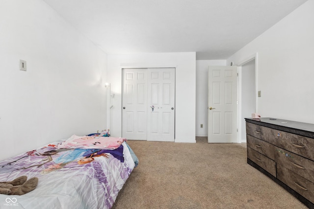 bedroom with light carpet and a closet