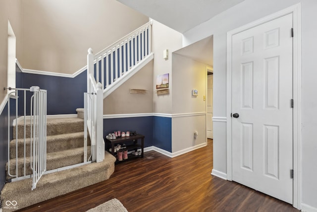 staircase with hardwood / wood-style floors