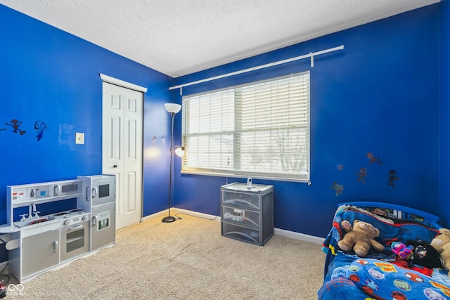 carpeted bedroom featuring a closet and a textured ceiling