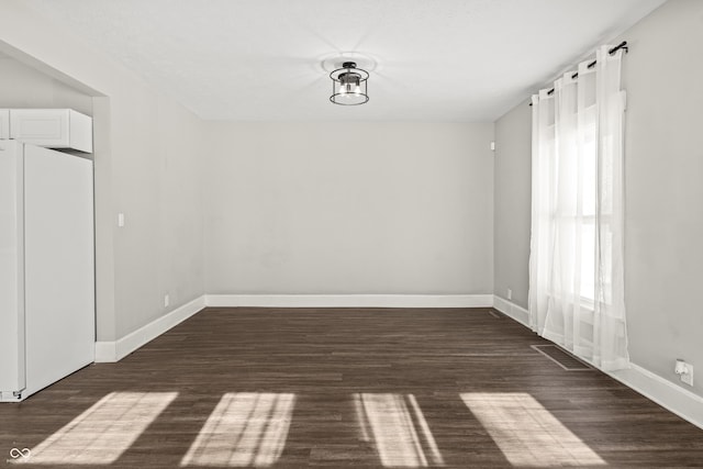 unfurnished room featuring dark hardwood / wood-style floors