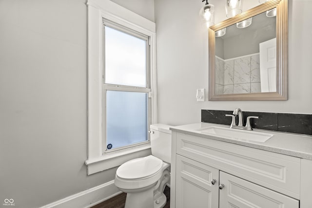 bathroom with hardwood / wood-style flooring, vanity, and toilet