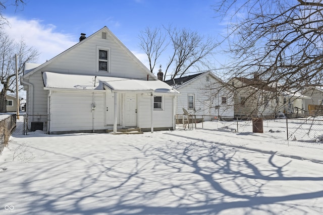 snow covered property with central AC unit