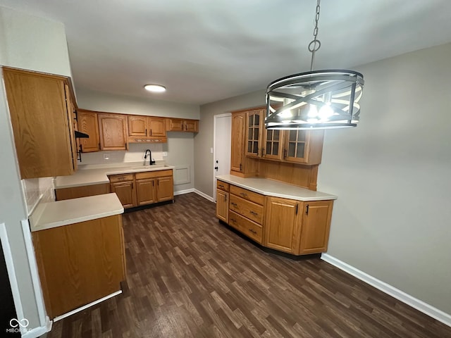 kitchen with sink, hanging light fixtures, dark hardwood / wood-style flooring, and a notable chandelier