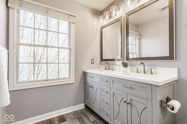 full bathroom with a wealth of natural light, visible vents, and a sink