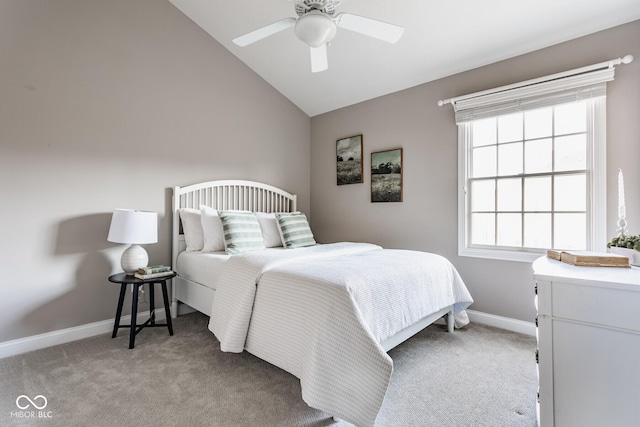 bedroom with lofted ceiling, baseboards, and light carpet