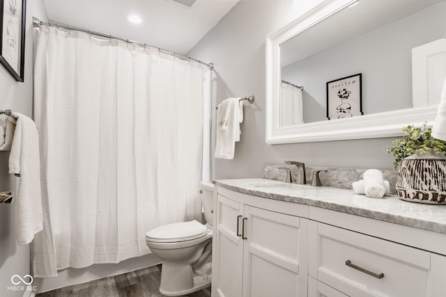 full bath featuring visible vents, toilet, vanity, and wood finished floors