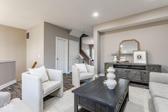 living room with visible vents, baseboards, stairway, recessed lighting, and wood finished floors