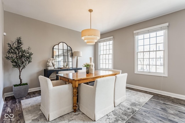 dining area with light wood-style flooring and baseboards