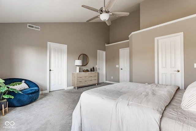 bedroom with a ceiling fan, carpet, visible vents, high vaulted ceiling, and baseboards