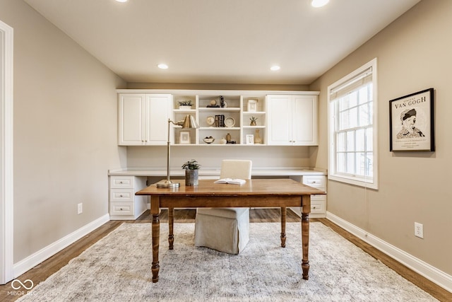 office area with built in desk, recessed lighting, dark wood-type flooring, and baseboards