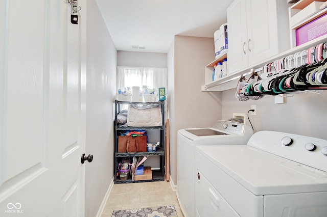 washroom with cabinets and separate washer and dryer