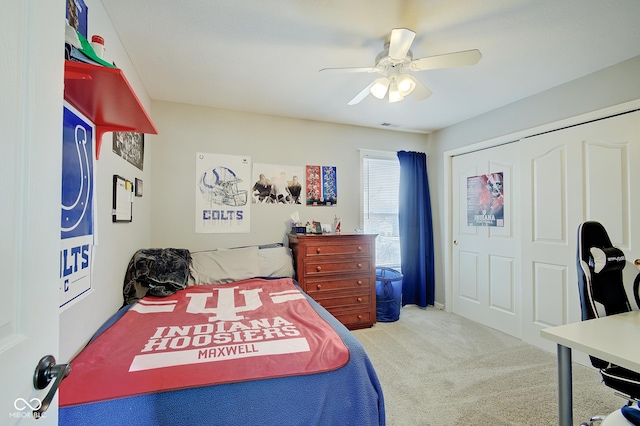 bedroom featuring a closet, ceiling fan, and carpet flooring