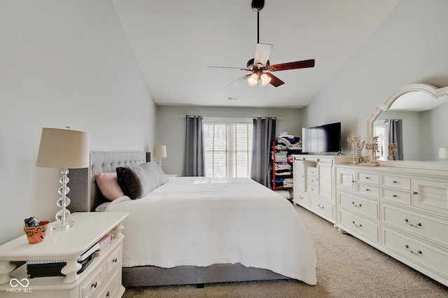 carpeted bedroom with vaulted ceiling and ceiling fan