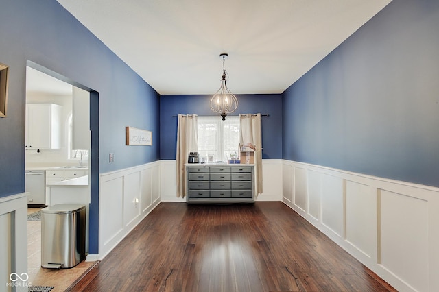 unfurnished dining area with sink and dark hardwood / wood-style flooring