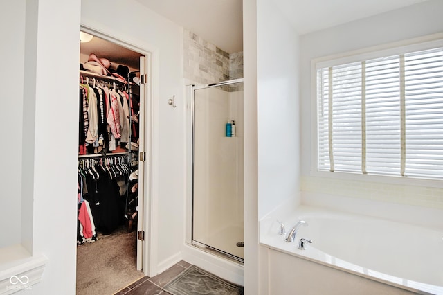 bathroom featuring tile patterned flooring and shower with separate bathtub