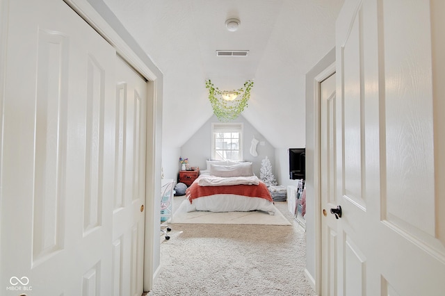 carpeted bedroom featuring vaulted ceiling