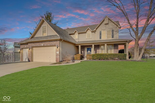 5230 Berkshire S Blvd, Greenwood, IN 46142 - view of front facade featuring brick siding, a yard, driveway, and covered porch