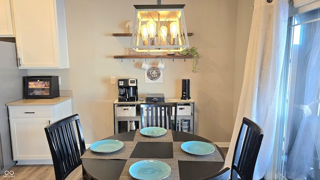 dining room featuring a chandelier and light hardwood / wood-style flooring