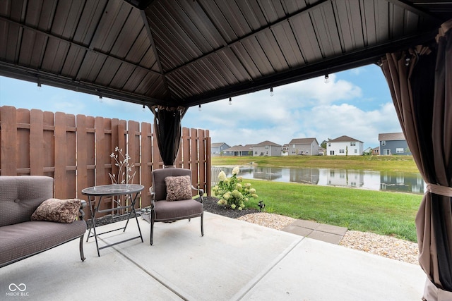 view of patio with a water view and a gazebo