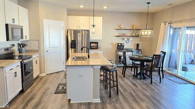 kitchen with white cabinetry, pendant lighting, and appliances with stainless steel finishes