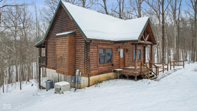 snow covered property featuring cooling unit