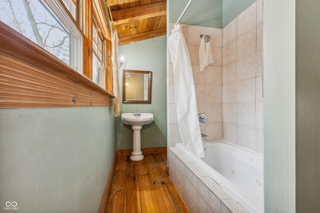 bathroom with wooden ceiling, hardwood / wood-style floors, and shower / tub combo with curtain