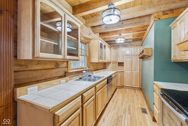 kitchen with appliances with stainless steel finishes, tile counters, light brown cabinets, wooden ceiling, and beam ceiling