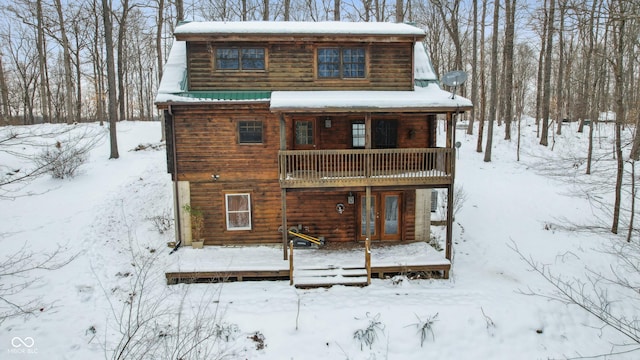 snow covered house with a balcony