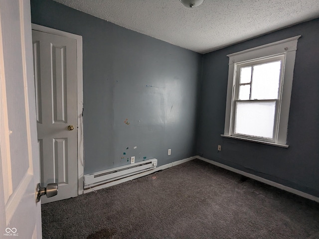 carpeted empty room featuring baseboard heating and a textured ceiling