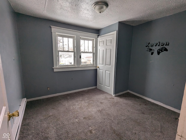 unfurnished bedroom with carpet, a baseboard heating unit, and a textured ceiling