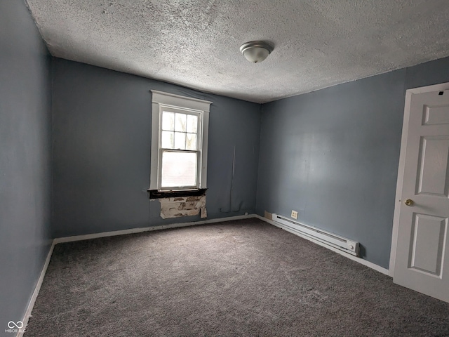 carpeted empty room featuring baseboard heating and a textured ceiling