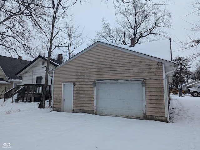 snow covered property featuring a garage