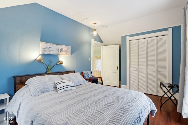 bedroom featuring a closet, lofted ceiling, and dark hardwood / wood-style floors